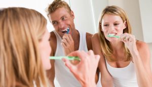 A Couple Brushing Their Teeth